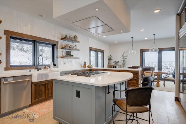 280 High Ridge Rd, Bozeman, MT 59715 - kitchen with light countertops, a center island, gas stovetop, dishwasher, and a sink