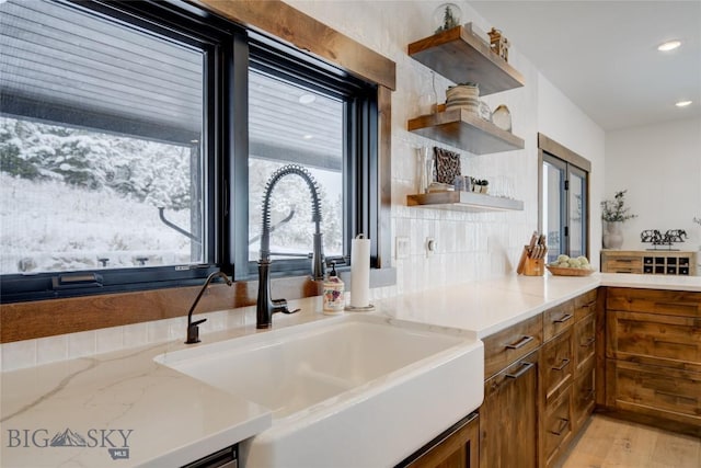 280 High Ridge Rd, Bozeman, MT 59715 - kitchen featuring open shelves, a sink, brown cabinetry, recessed lighting, and light stone counters