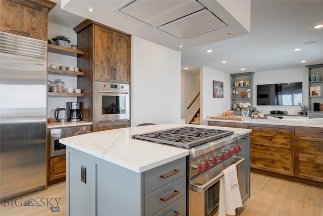 280 High Ridge Rd, Bozeman, MT 59715 - kitchen featuring light stone counters, light wood-style flooring, open shelves, a kitchen island, and premium appliances