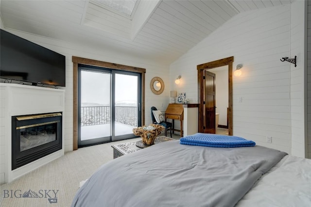 280 High Ridge Rd, Bozeman, MT 59715 - carpeted bedroom featuring access to exterior, a glass covered fireplace, and vaulted ceiling
