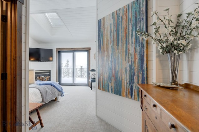 280 High Ridge Rd, Bozeman, MT 59715 - bedroom featuring access to outside, a glass covered fireplace, carpet, and a skylight