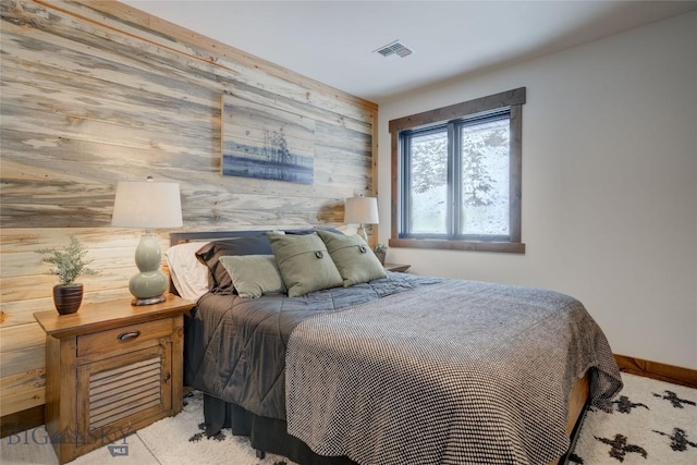 280 High Ridge Rd, Bozeman, MT 59715 - bedroom with light colored carpet, wooden walls, baseboards, and visible vents