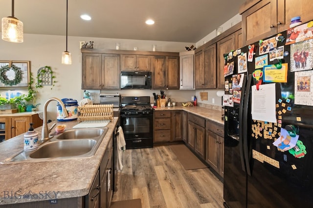 1519 Butler Crk Unit B, Belgrade, MT 59714 - kitchen featuring black appliances, a sink, light wood finished floors, decorative light fixtures, and recessed lighting