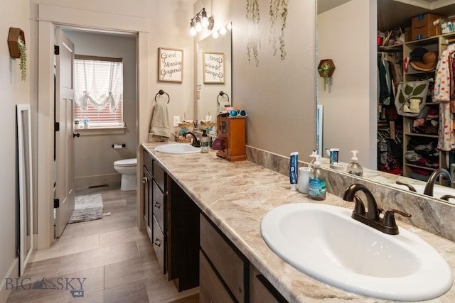 1519 Butler Crk Unit B, Belgrade, MT 59714 - full bath with toilet, double vanity, baseboards, and a spacious closet
