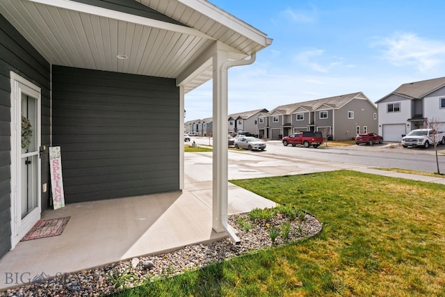 1519 Butler Crk Unit B, Belgrade, MT 59714 - view of green lawn with a residential view and a porch