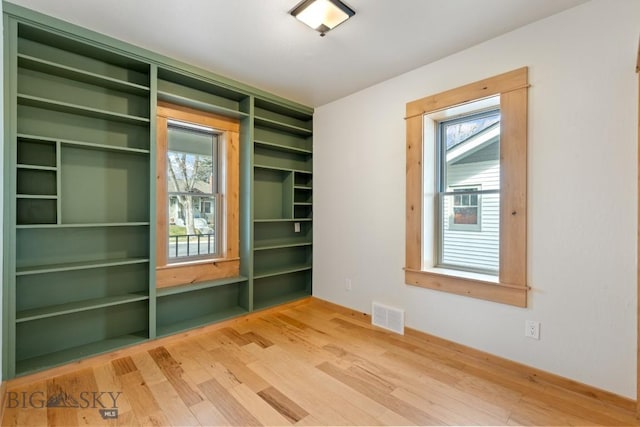 614 S 6th, Bozeman, MT 59715 - unfurnished room with visible vents and wood finished floors