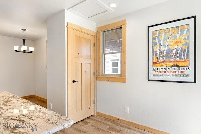 614 S 6th, Bozeman, MT 59715 - unfurnished dining area featuring baseboards, light wood finished floors, and an inviting chandelier