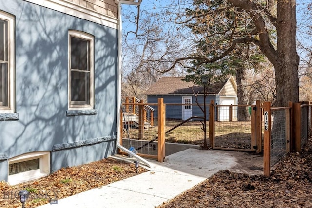 614 S 6th, Bozeman, MT 59715 - view of side of home featuring fence, an outdoor structure, and a gate