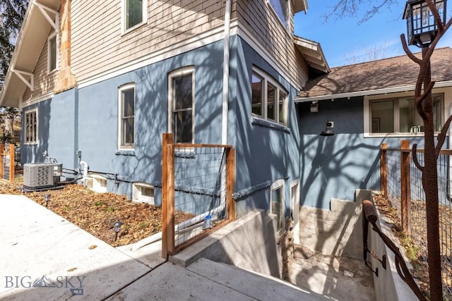 614 S 6th, Bozeman, MT 59715 - view of side of home with cooling unit and stucco siding