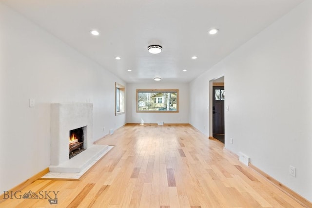 614 S 6th, Bozeman, MT 59715 - unfurnished living room featuring recessed lighting, light wood finished floors, a premium fireplace, and baseboards