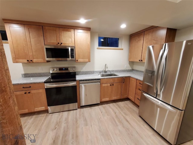 614 S 6th, Bozeman, MT 59715 - kitchen featuring a sink, recessed lighting, light wood finished floors, stainless steel appliances, and light stone counters