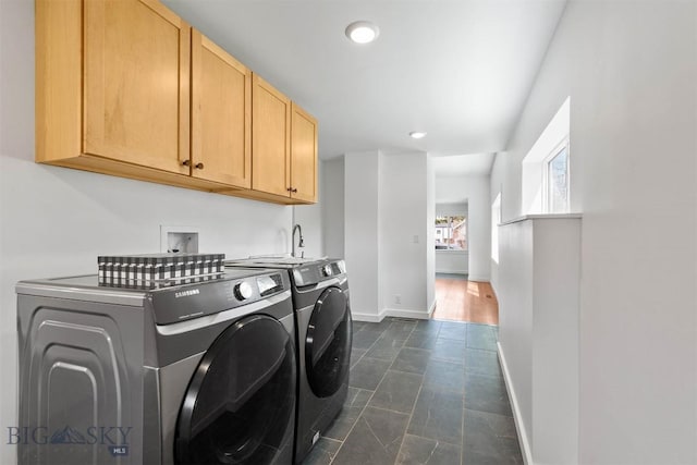 washroom featuring baseboards, cabinet space, washing machine and dryer, and recessed lighting
