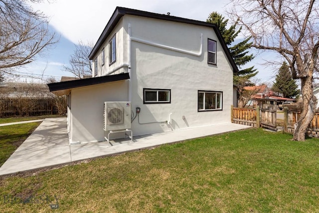 back of property featuring a patio area, fence, and a lawn
