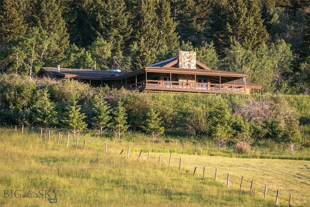 view of front of home featuring a view of trees
