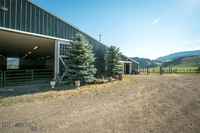 view of horse barn featuring a mountain view