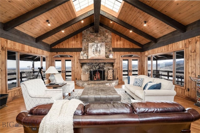 living area with wood finished floors, wooden walls, and beamed ceiling