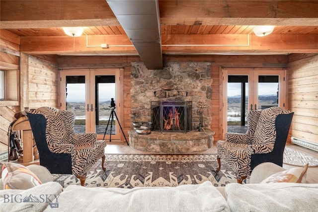 living area with french doors, wooden ceiling, and beam ceiling