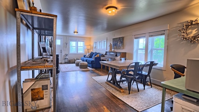 dining area featuring baseboards and wood finished floors