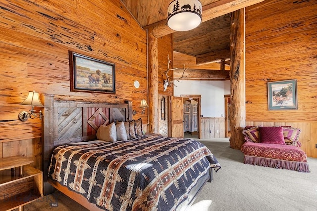 569/571 Cinnabar Basin Rd, Gardiner, MT 59030 - bedroom with wood walls, wood ceiling, carpet floors, and beamed ceiling