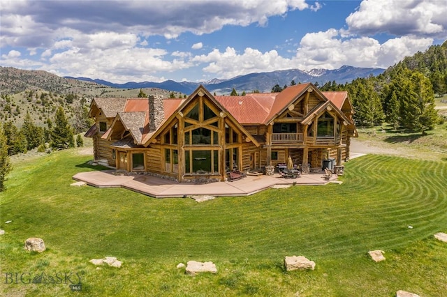 569/571 Cinnabar Basin Rd, Gardiner, MT 59030 - rear view of house with a yard, log siding, and a chimney