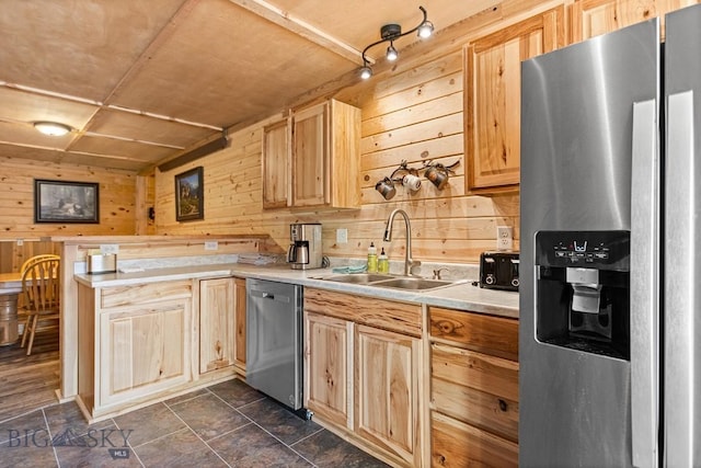 569/571 Cinnabar Basin Rd, Gardiner, MT 59030 - kitchen with appliances with stainless steel finishes, a sink, light brown cabinetry, wood walls, and light countertops