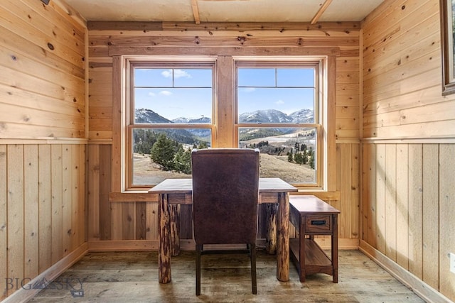 569/571 Cinnabar Basin Rd, Gardiner, MT 59030 - dining space featuring hardwood / wood-style floors, a mountain view, wooden walls, and healthy amount of natural light
