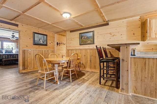 569/571 Cinnabar Basin Rd, Gardiner, MT 59030 - dining room featuring wooden walls, wood finished floors, and baseboards