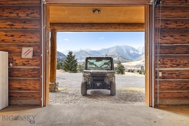 569/571 Cinnabar Basin Rd, Gardiner, MT 59030 - entryway featuring rustic walls, a mountain view, and carpet