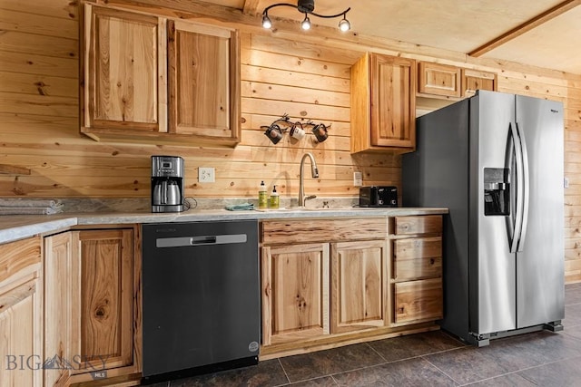 569/571 Cinnabar Basin Rd, Gardiner, MT 59030 - kitchen featuring stainless steel appliances, wooden walls, a sink, light countertops, and dark tile patterned flooring