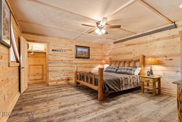 569/571 Cinnabar Basin Rd, Gardiner, MT 59030 - bedroom featuring wooden walls, wood finished floors, and a ceiling fan