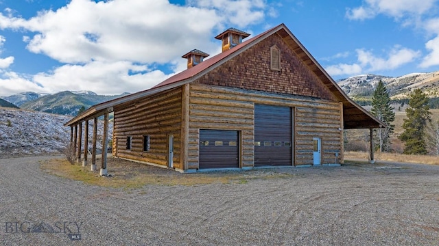 569/571 Cinnabar Basin Rd, Gardiner, MT 59030 - view of property exterior featuring a mountain view, a detached garage, and an outdoor structure