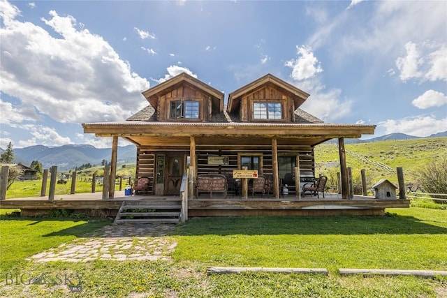 569/571 Cinnabar Basin Rd, Gardiner, MT 59030 - rear view of property featuring a mountain view, a lawn, and a porch