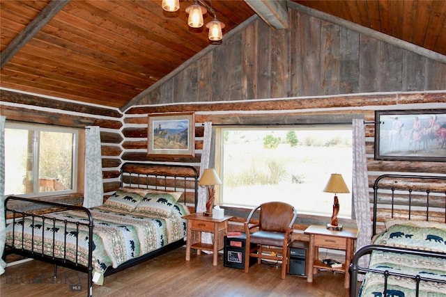 569/571 Cinnabar Basin Rd, Gardiner, MT 59030 - bedroom with wood ceiling, lofted ceiling, hardwood / wood-style floors, multiple windows, and rustic walls