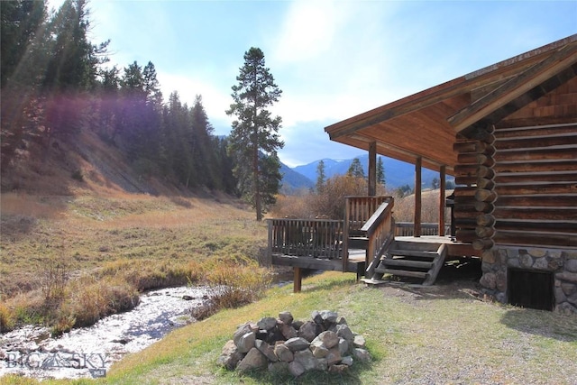 569/571 Cinnabar Basin Rd, Gardiner, MT 59030 - view of yard with a deck with mountain view and an outdoor fire pit