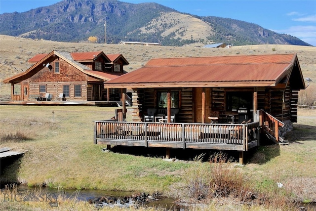 569/571 Cinnabar Basin Rd, Gardiner, MT 59030 - back of property featuring log siding and a deck with mountain view