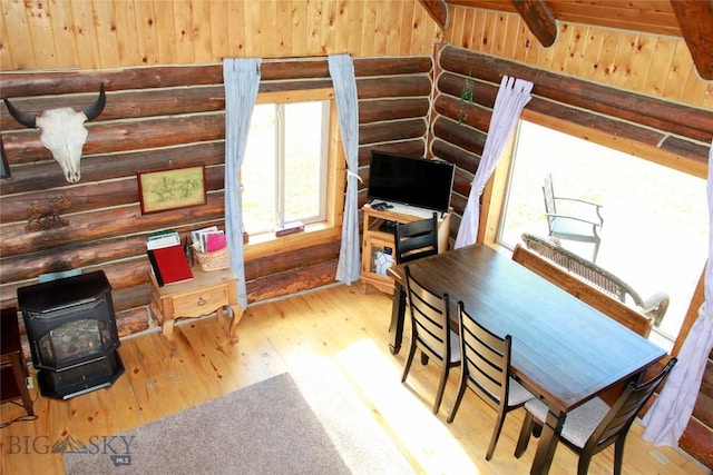 569/571 Cinnabar Basin Rd, Gardiner, MT 59030 - office with a wood stove, rustic walls, and hardwood / wood-style flooring