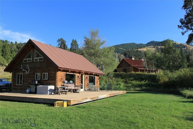 569/571 Cinnabar Basin Rd, Gardiner, MT 59030 - view of green lawn featuring a deck with mountain view