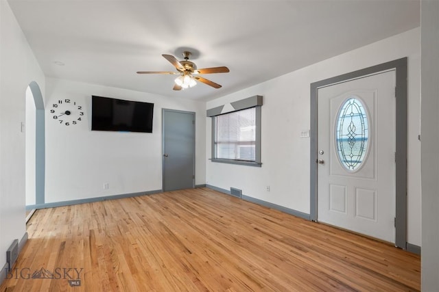 1814 Hamburg Ave, Anaconda, MT 59871 - foyer featuring healthy amount of natural light, a ceiling fan, arched walkways, and light wood-type flooring
