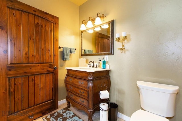 46 Rapelje Rd, Big Timber, MT 59011 - bathroom with toilet, vanity, and baseboards