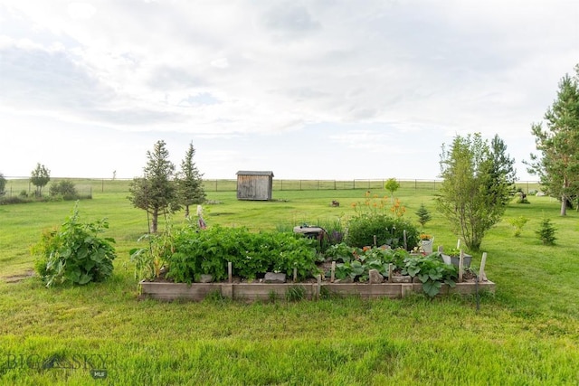 46 Rapelje Rd, Big Timber, MT 59011 - view of yard with an outdoor structure, a rural view, a vegetable garden, fence, and a storage unit