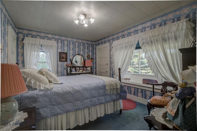 bedroom with wallpapered walls, baseboards, and carpet floors