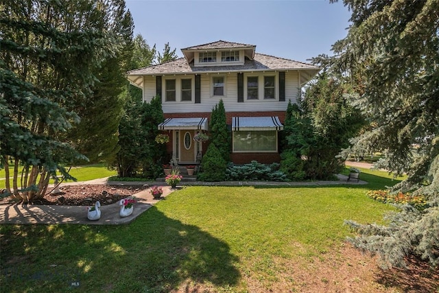 view of front of property with brick siding and a front lawn