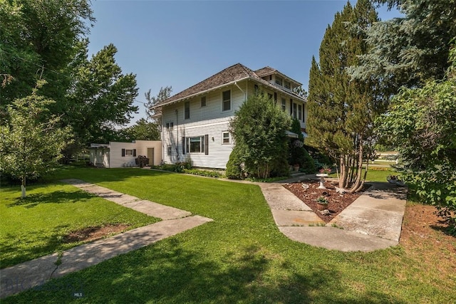 rear view of house featuring a lawn