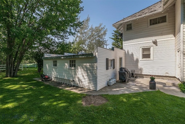 back of house featuring a yard and a patio area
