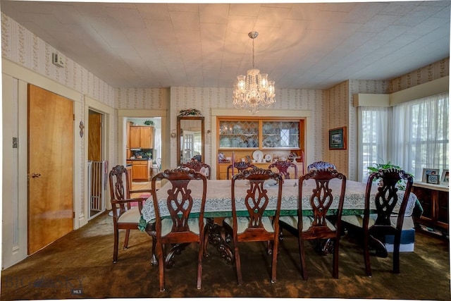 dining space featuring an inviting chandelier, wallpapered walls, and carpet floors
