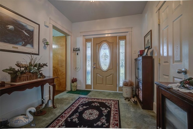 foyer entrance with carpet floors