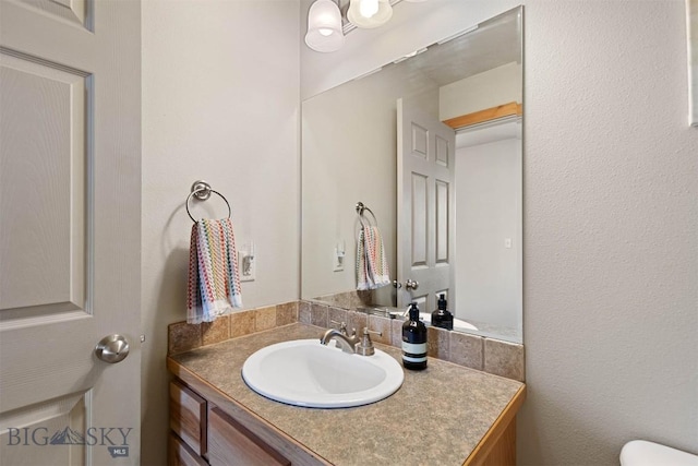 half bath with vanity and toilet