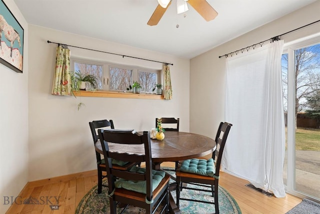 dining area featuring visible vents, ceiling fan, hardwood / wood-style floors, and a healthy amount of sunlight