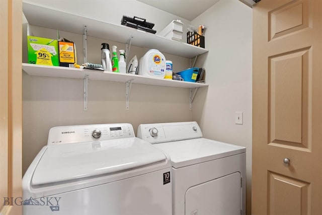 washroom featuring laundry area and washing machine and clothes dryer