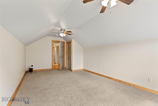 additional living space with baseboards, a ceiling fan, light carpet, and lofted ceiling